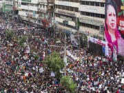 People gather in front of the Bangladesh Nationalist Party (BNP) headquarters during a protest rally in Dhaka, Bangladesh, Wednesday, Aug. 7, 2024.