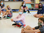 Fifth-graders wearing face masks are seated at proper social distancing during a music class at the Milton Elementary School in Rye, N.Y., on May 18, 2021.