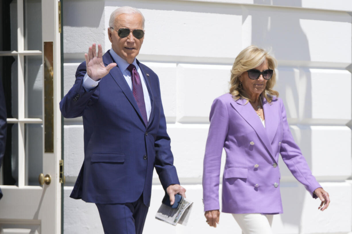 President Joe Biden and first lady Jill Biden walk out of the White House to board Marine One on the South Lawn in Washington, on Monday, for a trip to the Democratic National Convention in Chicago.