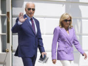 President Joe Biden and first lady Jill Biden walk out of the White House to board Marine One on the South Lawn in Washington, on Monday, for a trip to the Democratic National Convention in Chicago.