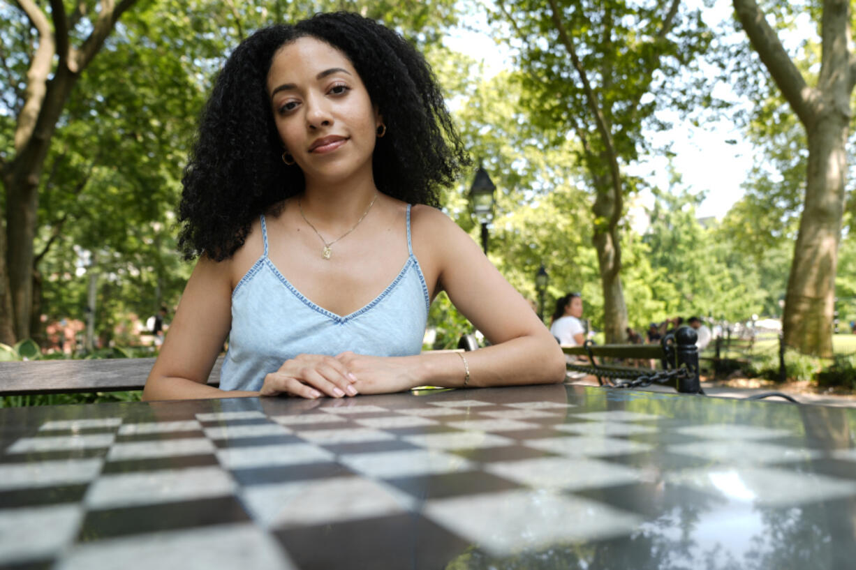 Juliana Pache sits July 16  in Washington Square Park in New York. In January 2023, she created blackcrossword.com, a site that offers a free mini-crossword puzzle every day.