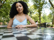 Juliana Pache sits July 16  in Washington Square Park in New York. In January 2023, she created blackcrossword.com, a site that offers a free mini-crossword puzzle every day.