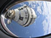 This photo provided by NASA shows Boeing&#039;s Starliner spacecraft which launched astronauts Butch Wilmore and Suni Williams to the International Space Station docked to the Harmony module&#039;s forward port on July 3, 2024, seen from a window on the SpaceX Dragon Endeavour spacecraft docked to the adjacent port.