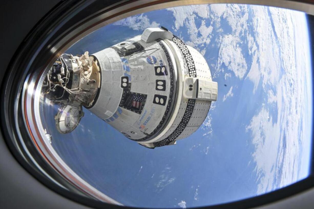 This photo provided by NASA shows Boeing&#039;s Starliner spacecraft which launched astronauts Butch Wilmore and Suni Williams to the International Space Station docked to the Harmony module&#039;s forward port on July 3, 2024, seen from a window on the SpaceX Dragon Endeavour spacecraft docked to the adjacent port.