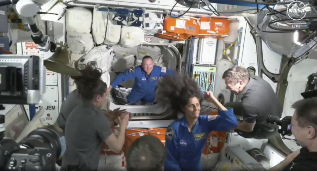 FILE - NASA astronauts Butch Wilmore and Suni Williams are welcomed by the crew of the International Space Station upon their arrival using the Boeing Starliner spacecraft on Thursday, June 6, 2024.