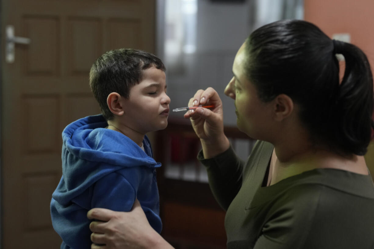 Janaina Silva gives a dose of liquid cannabidiol, or CBD, to her 4-year-old son Murillo after an epileptic seizure July 8 at her parents&rsquo; home in Guaruja, Brazil. Murillo takes regular doses of CBD that his mother acquires for free through Sao Paulo state&rsquo;s public health system.