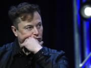 FILE - Tesla and SpaceX chief executive officer Elon Musk listens to a question as he speaks at the SATELLITE Conference and Exhibition in Washington, March 9, 2020.