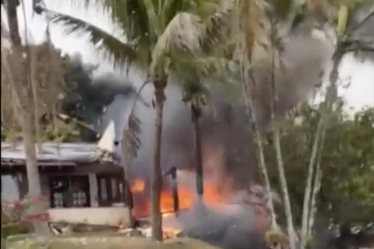 This frame grab from video shows fire coming from a plane that crashed by a home in Vinhedo, Sao Paulo state, Brazil, Friday, Aug. 9, 2024.