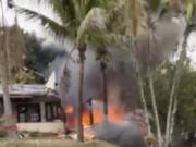 This frame grab from video shows fire coming from a plane that crashed by a home in Vinhedo, Sao Paulo state, Brazil, Friday, Aug. 9, 2024.