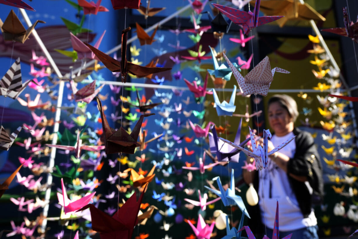 An origami installation of Japanese Tsuru, or the Crane, set up by Japan&rsquo;s community for world peace, hangs as part of events marking the 79th anniversary of the WWII bombing of Hiroshima and Nagasaki, in Brasilia, Brazil, Tuesday, Aug. 6, 2024.