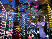 An origami installation of Japanese Tsuru, or the Crane, set up by Japan&rsquo;s community for world peace, hangs as part of events marking the 79th anniversary of the WWII bombing of Hiroshima and Nagasaki, in Brasilia, Brazil, Tuesday, Aug. 6, 2024.