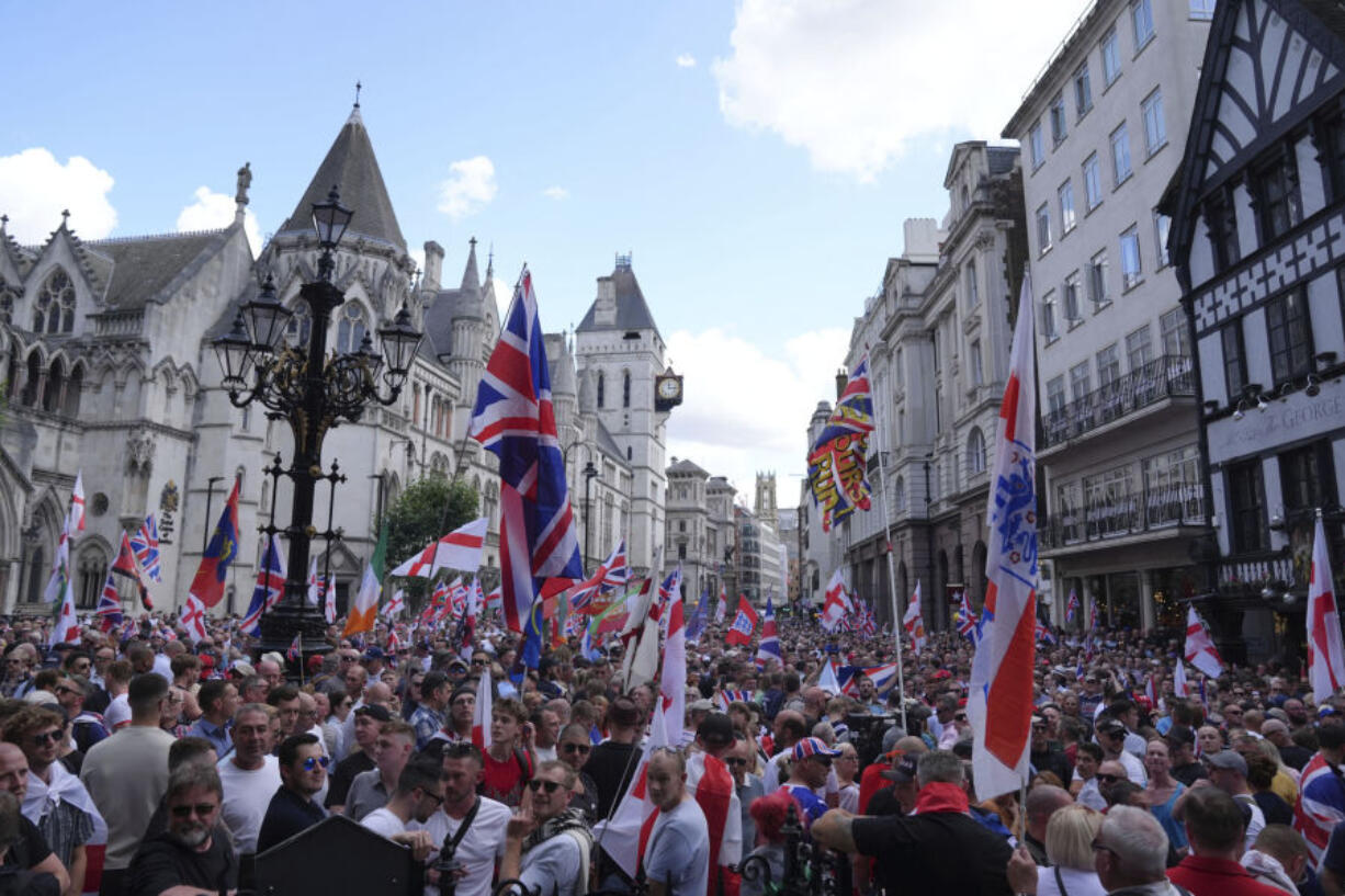 People take part in a protest march organised by Tommy Robinson, in central London, Saturday July 27, 2024. Thousands of protesters could be seen filling the Strand wearing clothing and holding flags depicting the Union, English, Scottish and Welsh flags. The crowd could be heard chanting &ldquo;Rule Britannia&rdquo;, &ldquo;We want our country back&rdquo; and Mr Robinson&rsquo;s name. In a post shared on X ahead of the protest, Mr Robinson, whose real name is Stephen Yaxley Lennon, said the protest would be &ldquo;the biggest patriotic rally the UK has ever seen&rdquo;.