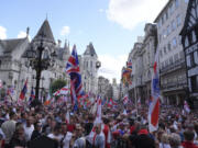 People take part in a protest march organised by Tommy Robinson, in central London, Saturday July 27, 2024. Thousands of protesters could be seen filling the Strand wearing clothing and holding flags depicting the Union, English, Scottish and Welsh flags. The crowd could be heard chanting &ldquo;Rule Britannia&rdquo;, &ldquo;We want our country back&rdquo; and Mr Robinson&rsquo;s name. In a post shared on X ahead of the protest, Mr Robinson, whose real name is Stephen Yaxley Lennon, said the protest would be &ldquo;the biggest patriotic rally the UK has ever seen&rdquo;.