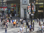 Police cordon off an area in Leicester Square, as a man was arrested with the accusation of stabbing an 11-year-old girl and 34-year-old woman, in London, Monday Aug. 12, 2024.