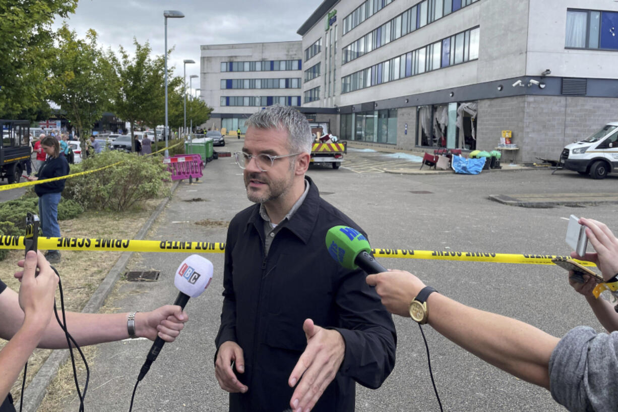 Oliver Coppard, South Yorkshire Mayor, speaks to the media outside the Holiday Inn Express where anti-immigration rioters smashed the windows before starting fires on Sunday, in Rotherham, England, Monday, Aug. 5, 2024. Lawlessness has swept the country over the past six days as right-wing activists used social media to spread misinformation to whip up anger over a stabbing rampage at a dance class that left three girls dead and many more wounded.