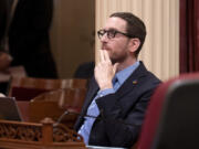 FILE - State Sen. Scott Wiener, D-San Francisco, watches as the Senate votes on a measure at the Capitol in Sacramento, Calif., Thursday, April 11, 2024.