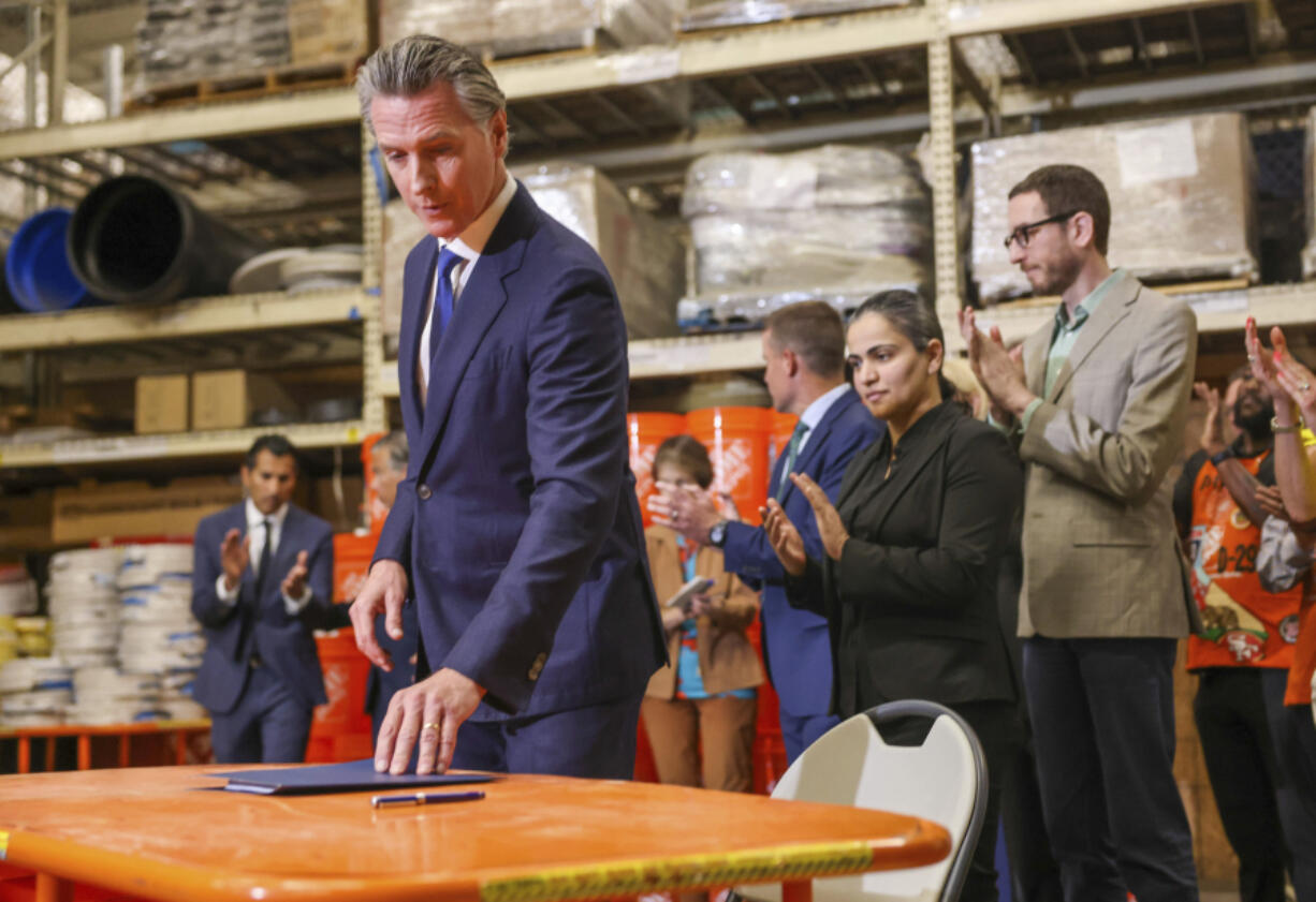 California Gov. Gavin Newsom prepares to sign bills to combat retail crime during a press conference with state and local officials at Home Depot in San Jose, Calif., on Friday.