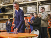 California Gov. Gavin Newsom prepares to sign bills to combat retail crime during a press conference with state and local officials at Home Depot in San Jose, Calif., on Friday.