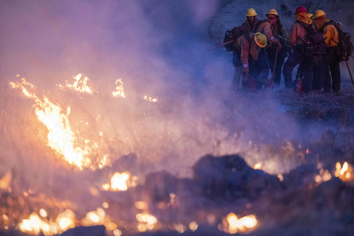 Fire crews light a burn operation along Highway 36 to slow the Park Fire near Dales, Calif., Monday, July 29, 2024.