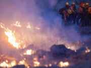 Fire crews light a burn operation along Highway 36 to slow the Park Fire near Dales, Calif., Monday, July 29, 2024.