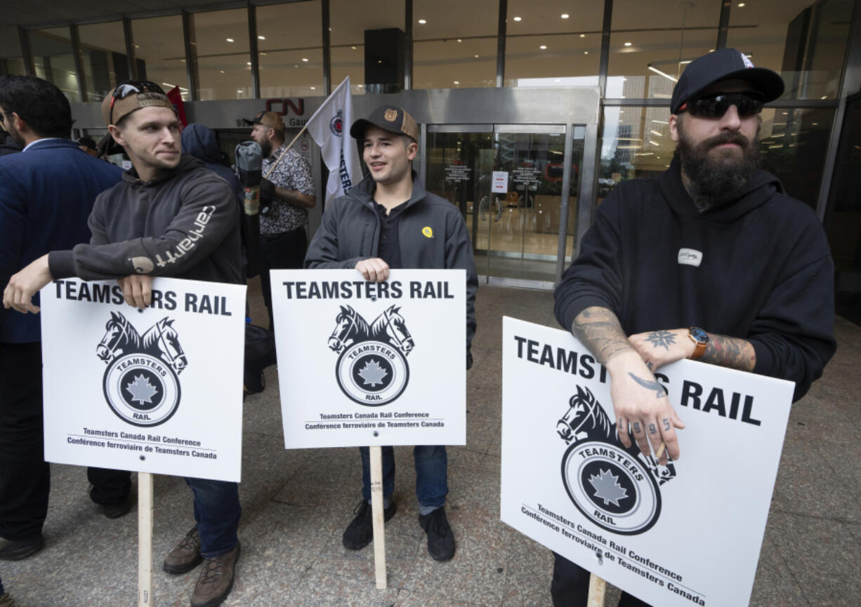 Rail workers picket in front of Canadian National headquarters on the first day of a nationwide rail shutdown, after workers were locked out by  Canadian National and CPKC when new contract agreements weren&rsquo;t reached by the midnight deadline, in Montreal, Thursday, Aug. 22, 2024.