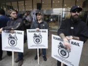 Rail workers picket in front of Canadian National headquarters on the first day of a nationwide rail shutdown, after workers were locked out by  Canadian National and CPKC when new contract agreements weren&rsquo;t reached by the midnight deadline, in Montreal, Thursday, Aug. 22, 2024.