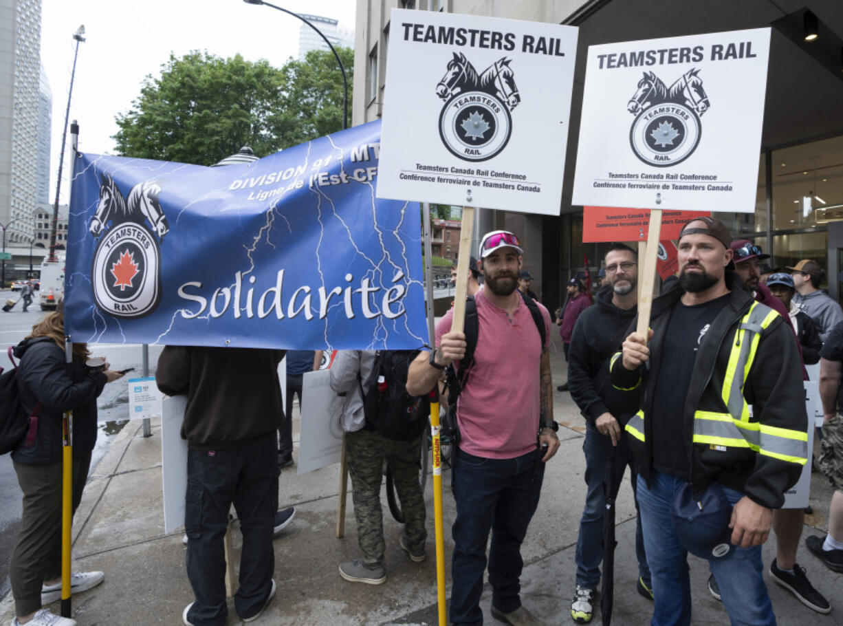 Rail workers picket in front of CN headquarters on the first day of a nationwide rail shutdown, after workers were locked out by CN and CPKC when new contract agreements weren&rsquo;t reached by the midnight deadline, in Montreal, Thursday, Aug. 22, 2024.