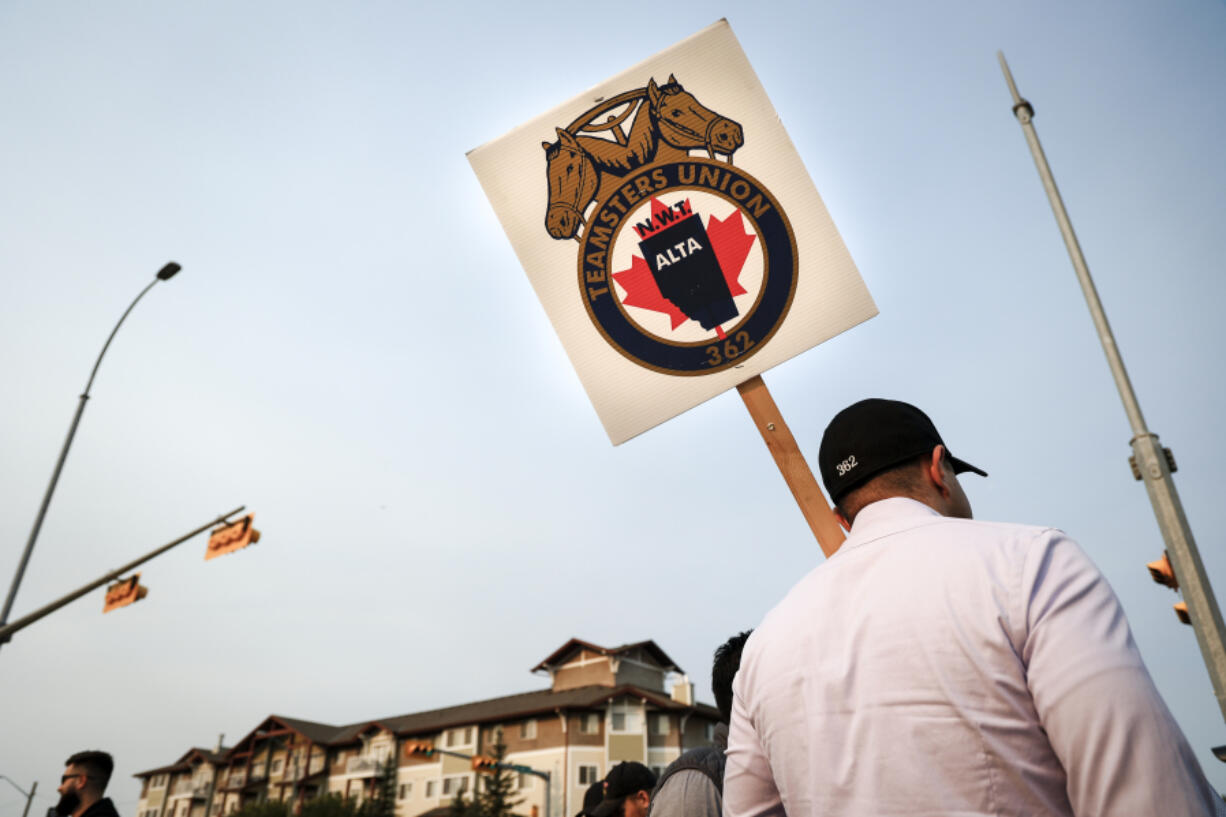 Teamsters Canada Rail Conference members picket outside the CPKC headquarters in Calgary, Alta., Friday, Aug. 23, 2024.