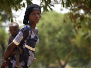 28-year-old Milla Nemoudji, a woman who was divorced by her husband following years of physical abuse, is photographed in a village of Binmar, Chad, Friday, July 19, 2024.