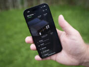 Jason Benedict shows an app on his phone with solar energy readings of his home in Berkley, Mich., Wednesday, July 24, 2024.