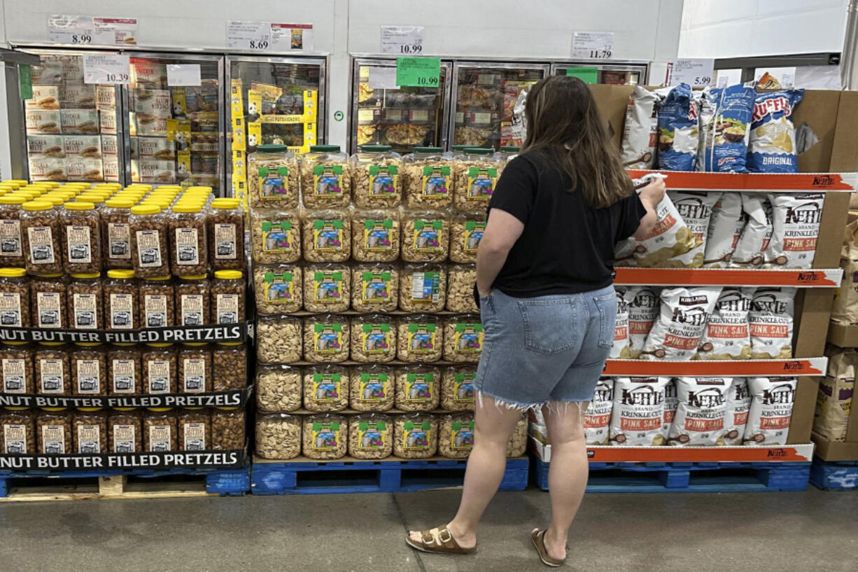 A shopper considers a purchase in a Costco warehouse Thursday, Aug. 22, 2024, in Parker, Colo.