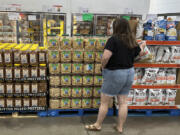 A shopper considers a purchase in a Costco warehouse Thursday, Aug. 22, 2024, in Parker, Colo.