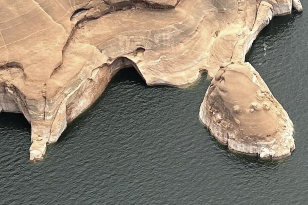 This photo provided by the National Park Service shows the Double Arch, center, after the collapse, Friday, August 9th, 2024, in Rock Creek Bay of the Glen Canyon National Recreation Area, Utah. (Jacob E.