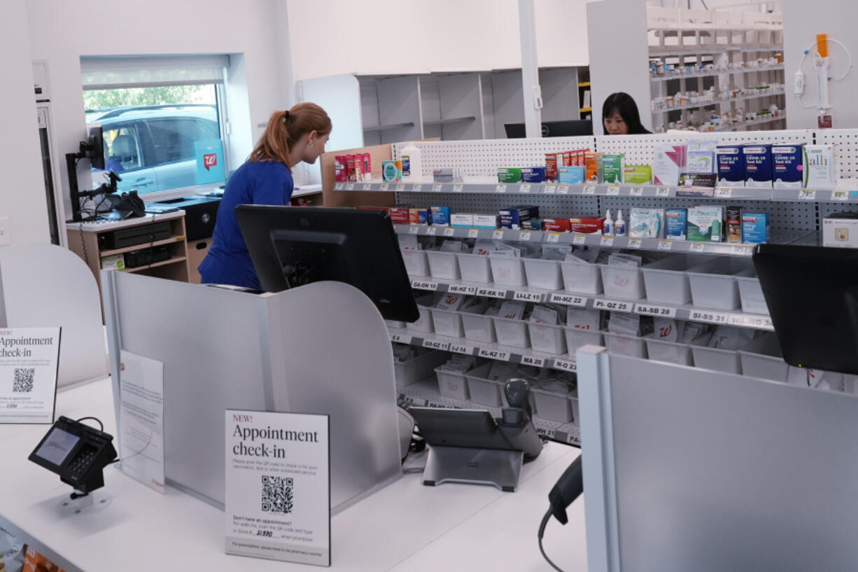 Pharmacy technicians work at a Walgreens pharmacy store in Deerfield, Ill., Thursday, July 25, 2024. America&rsquo;s drugstores are testing smaller locations and making bigger bets on health care as they adjust to customers who need them less for convenience. (AP Photo/Nam Y. Huh) (Nam Y.