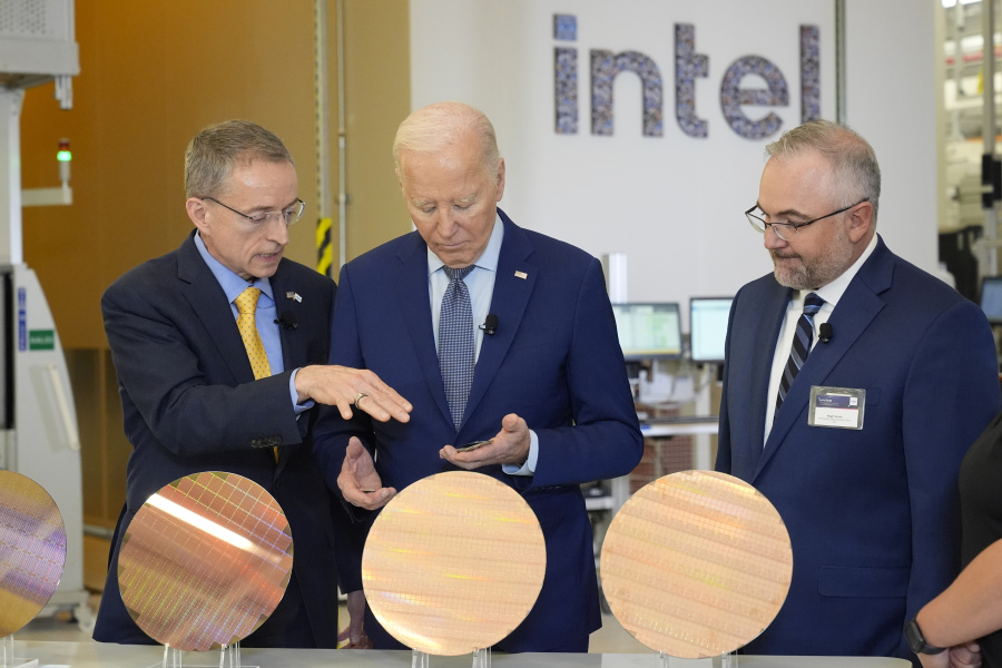 FILE - President Joe Biden listens to Intel CEO Pat Gelsinger, left, as Intel factory manager Hugh Green watches during a tour of the Intel Ocotillo Campus, in Chandler, Ariz., on March 20, 2024. Intel reports earnings on Thursday, Aug. 1, 2024.