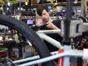 FILE - Mechanic Thomas Strater works at University Bicycles in Boulder, Colo., April 30, 2024. U.S. hiring decelerated sharply in July in the face of high interest rates as employers added a weak 114,000 jobs.