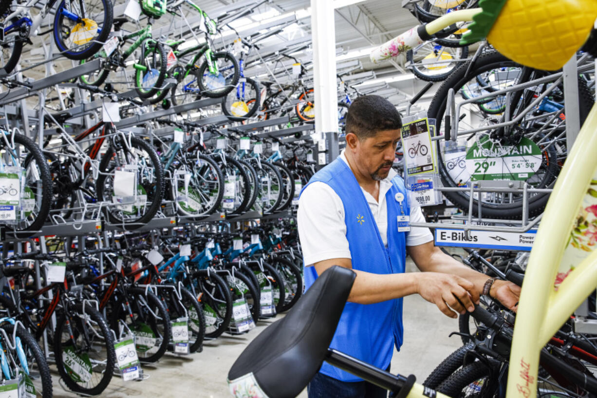 FILE - A worker organizes bicycles at a Walmart Superstore in Secaucus, New Jersey, July 11, 2024. Last month&rsquo;s rise in the unemployment rate has set off new worries about the threat of a recession, but it could also be a false alarm. The distorted post-pandemic economy has already confounded a host of traditional recession signals, at least so far.