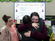 Shadows Myers, facing, hugs center receptionist Eryn Martin as Associate Educator Carrie McClure, left, looks on while they say their goodbyes following the last day of school at the Meadow Lakes CCS Early Learning, a Head Start center, Wednesday, May 8, 2024, in Wasilla, Alaska. To keep staff from leaving for higher-paying jobs elsewhere, even Target, the regional Head Start group decided it would permanently close the Meadow Lakes location at the end of the school year in an attempt to raise wages overall. About half the Meadow Lakes children and their families, many low income, hope to be granted a spot at a different Head Start center in the area, but there are few guarantees.