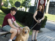 Tania Tetlow president of Fordham University holds her dog Archie as new students arrive during Move In Day at the Bronx campus, Sunday Aug. 25, 2024, in New York.