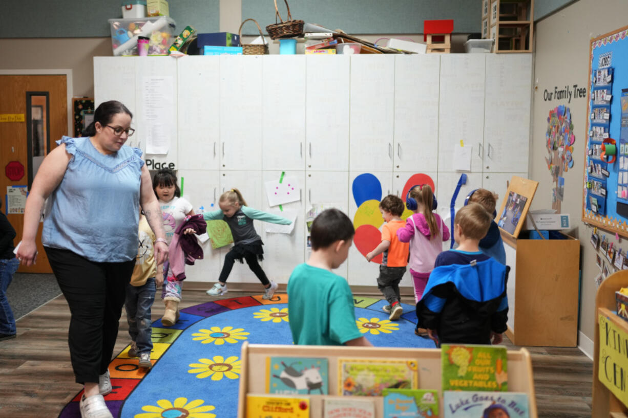 Family educator Lisa Benson-Nuyen, left, leads her students in a circle as they play music after eating breakfast in the Northern Lights classroom at the Meadow Lakes CCS Early Learning, a Head Start center, on Monday, in Wasilla, Alaska.