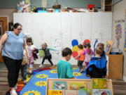 Family educator Lisa Benson-Nuyen, left, leads her students in a circle as they play music after eating breakfast in the Northern Lights classroom at the Meadow Lakes CCS Early Learning, a Head Start center, on Monday, in Wasilla, Alaska.