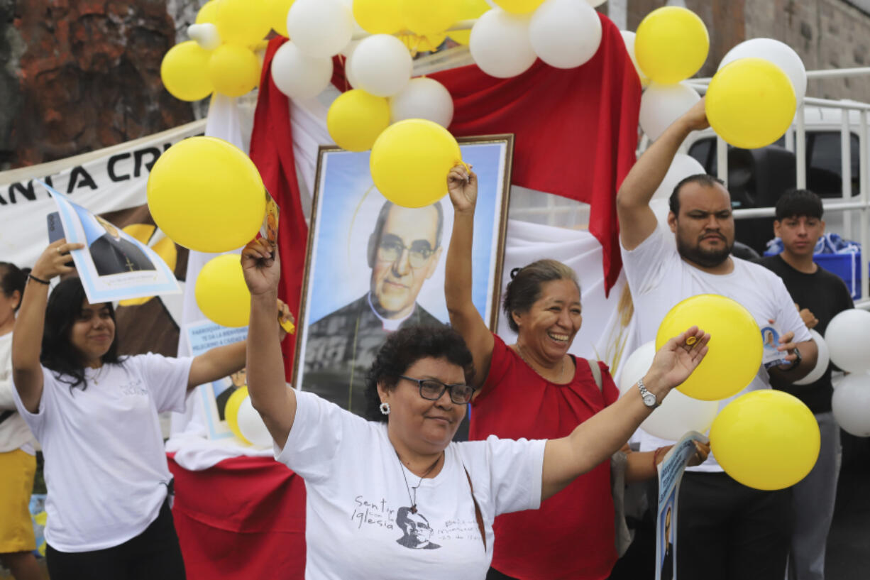 People carry balloons and an image of Saint Oscar Arnulfo Romero during a religious procession in his honor in San Salvador, El Salvador, Thursday, Aug. 1, 2024. Romero was assassinated on March 24, 1980, while celebrating Mass.