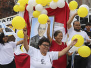 People carry balloons and an image of Saint Oscar Arnulfo Romero during a religious procession in his honor in San Salvador, El Salvador, Thursday, Aug. 1, 2024. Romero was assassinated on March 24, 1980, while celebrating Mass.