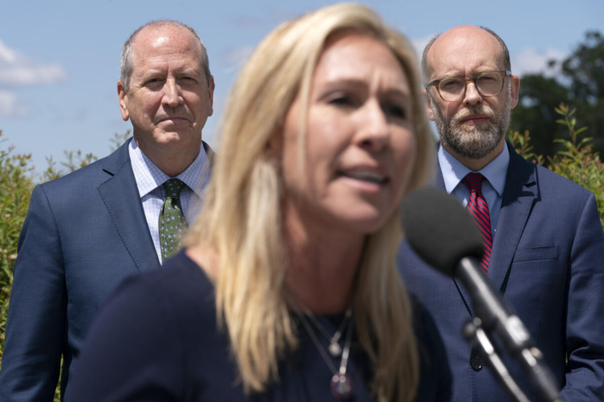 FILE - Rep. Marjorie Taylor Greene, R-Ga., center, speaks during a news conference, Wednesday, May 12, 2021, with Rep. Dan Bishop, R-N.C., back left, and former OMB Director and President of Citizens for Renewing America Russel Vought, as they express their opposition to &ldquo;critical race theory,&rdquo; on Capitol Hill in Washington.