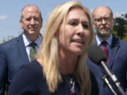 FILE - Rep. Marjorie Taylor Greene, R-Ga., center, speaks during a news conference, Wednesday, May 12, 2021, with Rep. Dan Bishop, R-N.C., back left, and former OMB Director and President of Citizens for Renewing America Russel Vought, as they express their opposition to &ldquo;critical race theory,&rdquo; on Capitol Hill in Washington.