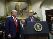 FILE - President Donald Trump listens as acting director of the Office of Management and Budget Russel Vought speaks during an event on &ldquo;transparency in Federal guidance and enforcement&rdquo; in the Roosevelt Room of the White House, Wednesday, Oct. 9, 2019, in Washington.