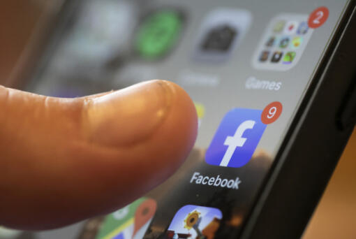 FILE - An iPhone displays the Facebook app, Aug. 11, 2019, in New Orleans. Russia, China and Iran are continuing to target voters in the U.S. with disinformation and propaganda related to the upcoming presidential election, top intelligence officials told reporters on Monday, July 29, 2024. Groups linked to the Kremlin are increasingly using private public relations firms or unwitting social media users to spread their false claims as a way to hide their tracks.