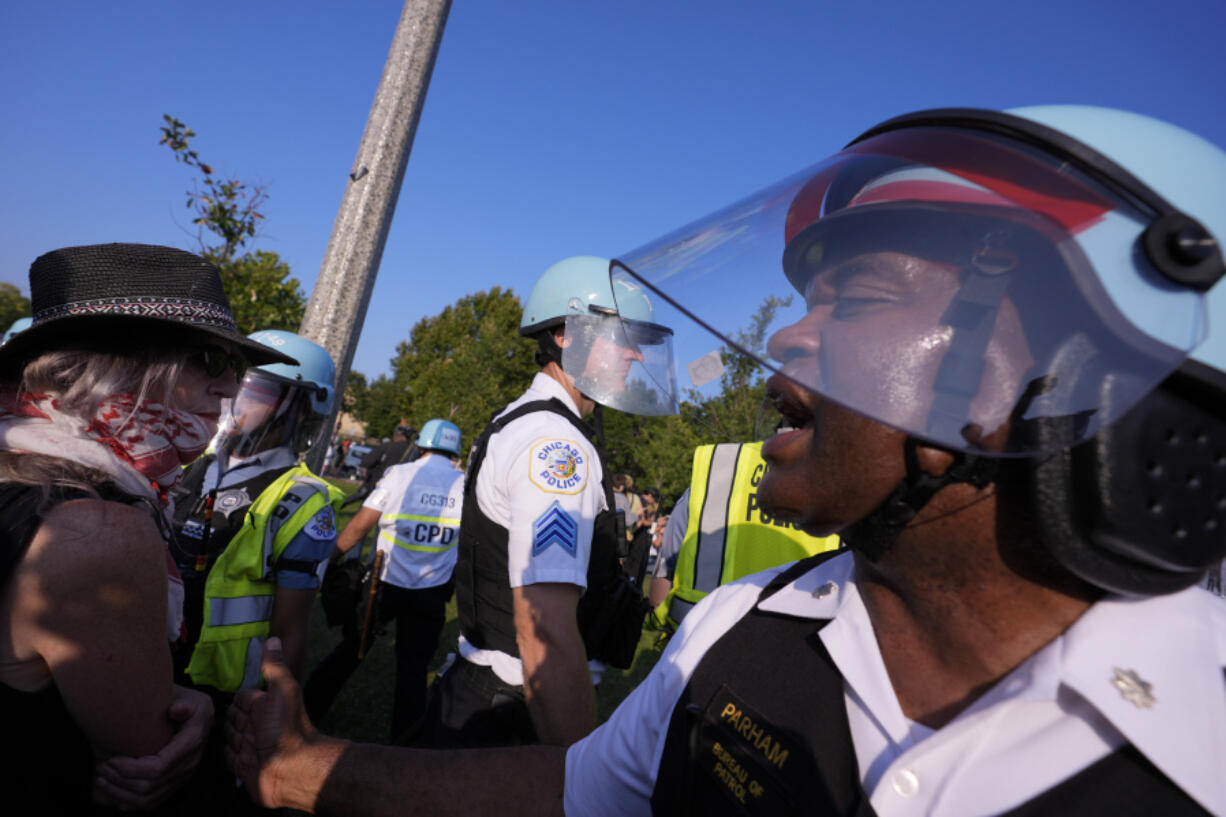 Police direct protesters at the United Center after a march at the Democratic National Convention Monday, Aug. 19, 2024, in Chicago.