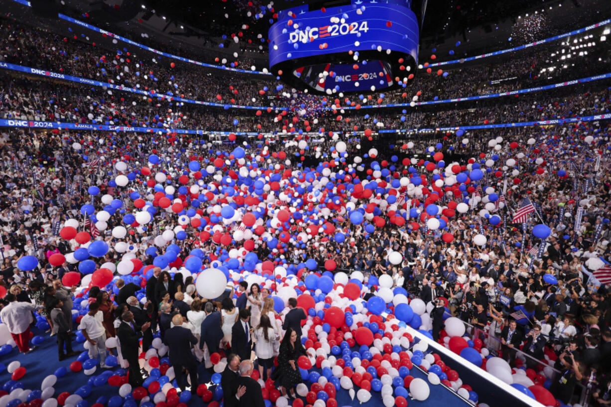 Balloons fall as Democratic presidential nominee Vice President Kamala Harris celebrates with her husband, second gentleman Doug Emhoff, Democratic vice presidential nominee Minnesota Gov. Tim Walz, his wife Gwen and their families on Day 4 of the Democratic National Convention, Thursday night, Aug. 23, 2024, at the United Center in Chicago.