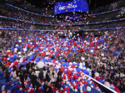 Balloons fall as Democratic presidential nominee Vice President Kamala Harris celebrates with her husband, second gentleman Doug Emhoff, Democratic vice presidential nominee Minnesota Gov. Tim Walz, his wife Gwen and their families on Day 4 of the Democratic National Convention, Thursday night, Aug. 23, 2024, at the United Center in Chicago.